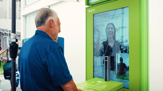 Testing the The Fure-au Denwa Connecting Life exhibit, testing the shared tactile sensations by touching tables located in front of monitors