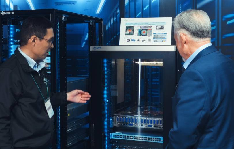 Dr. Norio Sato, Group Leader Device Innovation Center, NTT, Inc., showing a hardware device